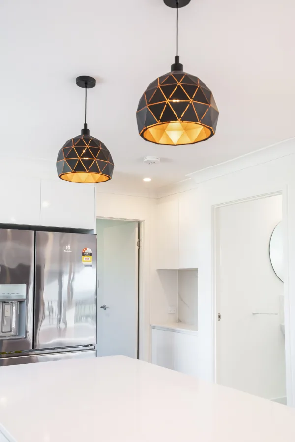 Butler's pantry passage with pendant lighting and an integrated fridge
